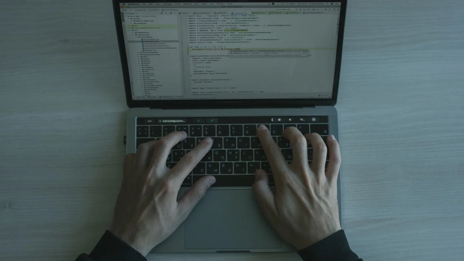 Developer working on laptop with code editor open